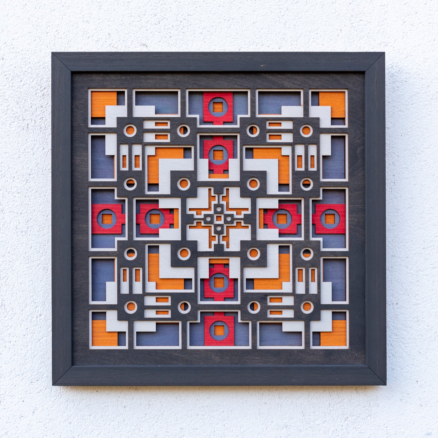 Noughts and crosses. A layered plywood artwork designed using geometric and symmetrical patterns. visually balanced wall art.