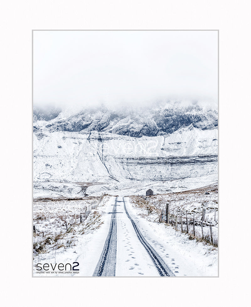 Trye tracks in snow with the old schoolhouse Gleniff horseshoe in background. Wild Atlantic Way