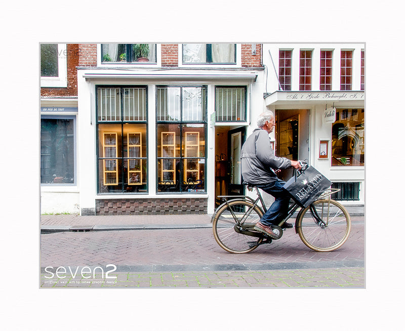 relaxed style, man on bike on Amsterdam street