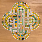 Irish Celtic knot wall art, modern Irish art,  layered wooden geometric maze design, handcrafted from 8 wood layers with heritage inspired green, yellow, and blue hues and colouring.